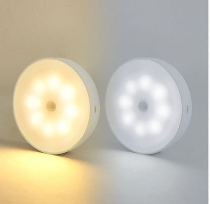 Warm white and cool white rechargeable motion-sensor puck lights side by side