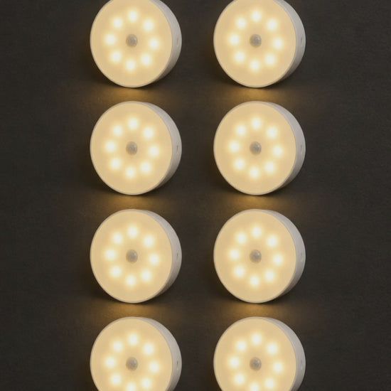 Eight Safe-Night motion-sensor lights switching on one by one on a dark wall